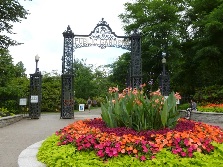 The Halifax Public Garden gates with a bright flower bed in the foreground